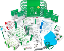 Full contents of the Mini First Aid 115-item Family Kit spread around the green pouch. Features a digital thermometer, foil blankets, instant cold pack, face shield, plasters, bandages, burn gels, and shears. Extensive medical set offering complete emergency protection for home and travel.