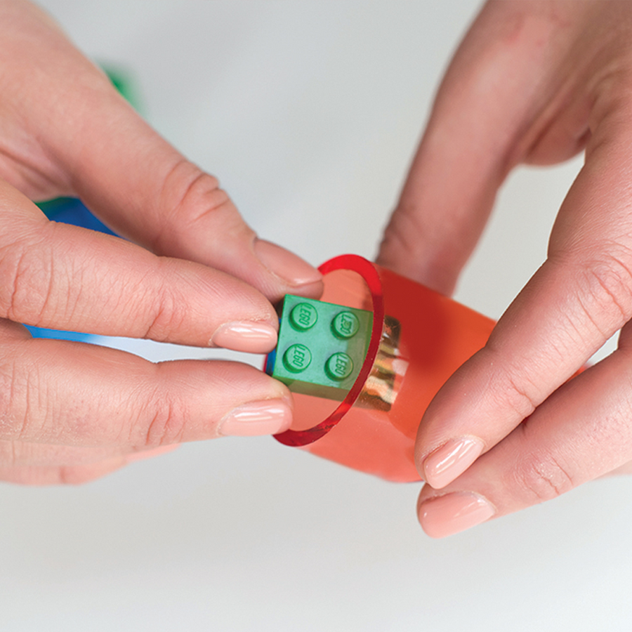 Child using the choke tester tool on a toy block